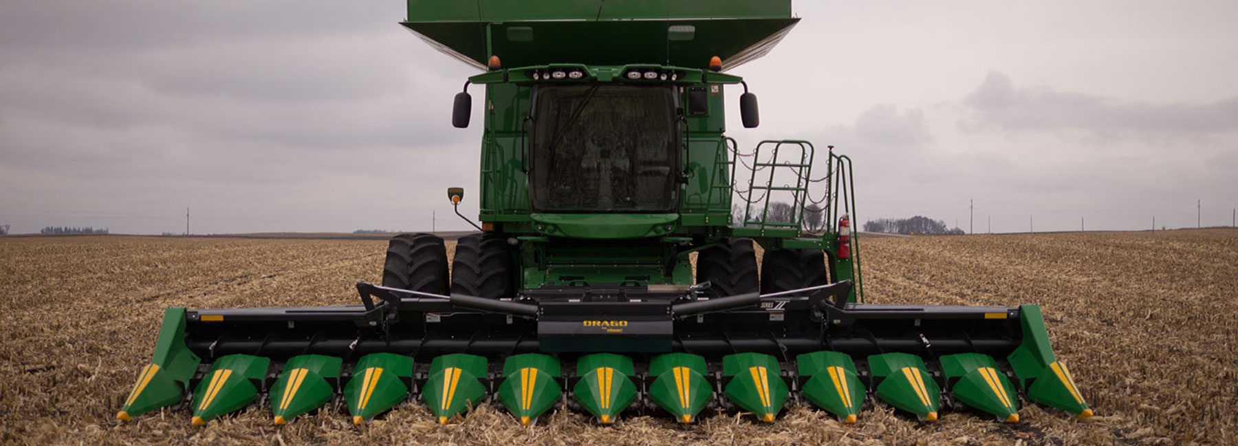 Drago corn head attached to conbine in a field